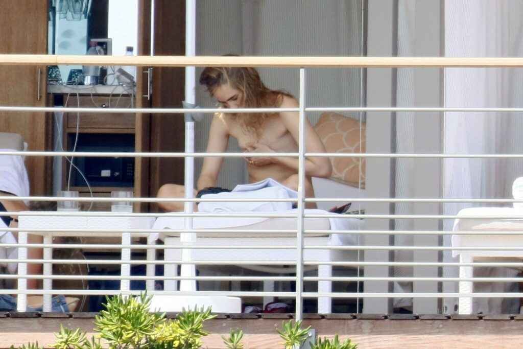 Suki Waterhouse seins nus sur un balcon